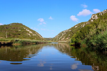 Beautiful summer  Landscape with river, blue sky and white clouds reflected in water. Nature of Portugal.