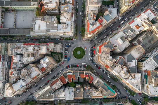 Aerial view of vehicles driving a roundabout in Thessaloniki downtown, Greece.