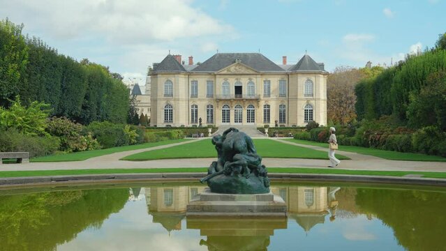 A young girl walking in the summer garden at the Rodin Museum