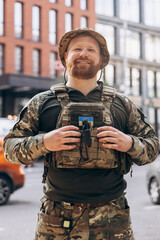 Fototapeta premium Portrait of Ukrainian soldier in uniform on the street