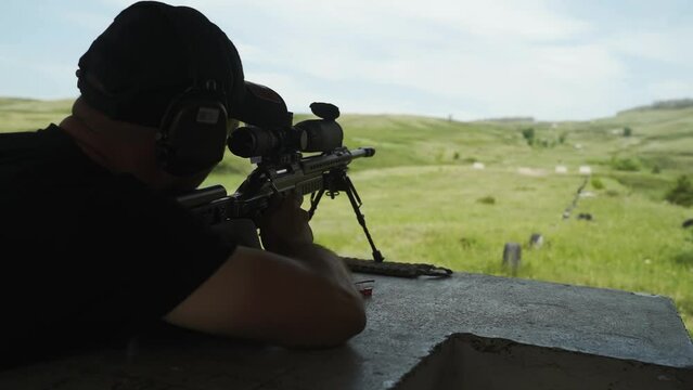a man shoots at a target on a shooting range with a rifle
