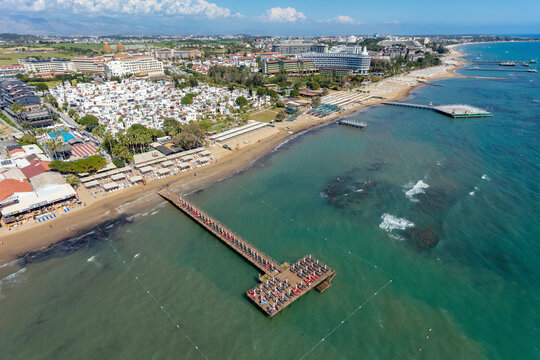 Aerial view of hotels, piers and beach in the Mediterranean Sea coast of Side, Antalya, Turkey.