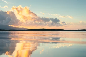 Selbstklebende Fototapete Reflection Seven seas beach with calm water reflecting the sky during the golden hour with clouds from fajardo, puerto rico.