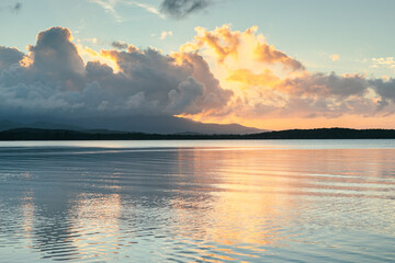 Seven seas beach with calm water reflecting the sky during the golden hour with clouds from fajardo, puerto rico.