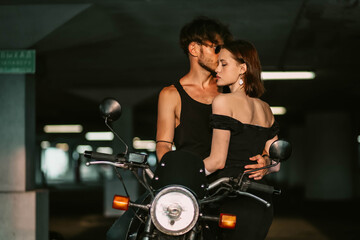Plakat sexy couple in love on a motorcycle. Love of a man and a woman and a motorcycle