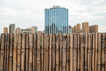 Bamboo fence with city skyline in the background in Chengdu, Sichuan province, China - 622658013