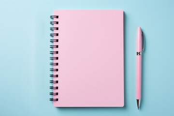 Blank pink notebook and pen flat lay, isolated on blue background - obrazy, fototapety, plakaty