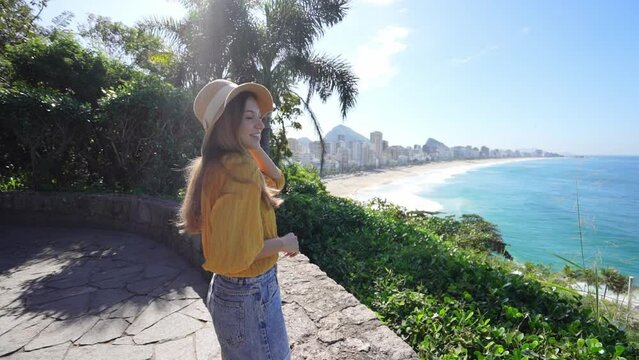 Stylish smiling tourist woman on viewpoint in Rio de Janeiro, Brazil