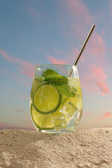 Mojito cocktail with citrus lime, lemon and orange on the beach