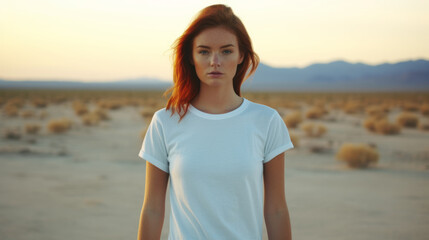 Redhead girl wearing crewneck white t-shirt standing in the desert