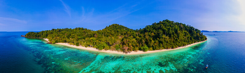 Le Morne beach Mauritius Tropical beach with palm trees and white sand blue ocean and beach beds with umbrellas, sun chairs, and parasols under a palm tree at a tropical beach. Mauritius Le Morne
