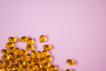 Cod liver fish oil omega 3 gel capsules isolated on pink horizontal banner background. Top view....