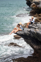 Group of women traveler enjoy the trip of hiking to the natural cliff in the sea, summer moment on trip traveling