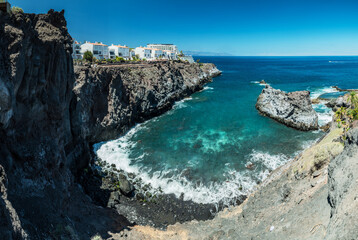 Jagged and dotted rocky coastline with amazing azur water  of Tenerife Island.