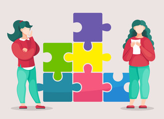 Two brunette girls working at solution of problem. Bussinesswomen working in team, cooperating together, seperated elements of colorful puzzle, making creative collective work, joint business
