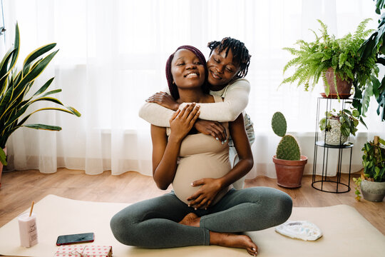 Black lesbian couple hugging while spending time together - Powered by Adobe