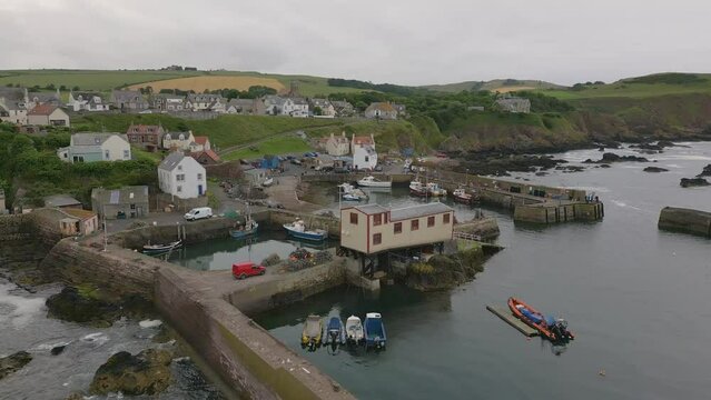Aerial drone video of the small harbour village St. Abbs in Berwickshire, Scotland