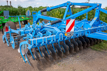 Disc harrow for tillage in areas with the remains of tall stalks of corn and sunflower on the...