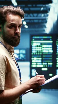 Vertical video Experienced system administrator maintenancing interlinked computers creating server network. Data storage service business using parallel computing to perform complex calculations