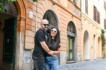 Happy  Beautiful Tourists  couple traveling at Rome, Italy, poses in front of  Colosseum  at, Rome, 