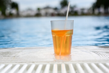  Summer refreshing  alcolcholic drink near a pool in a sunnny day.Aperol  Spritz,Italian popular cocktail