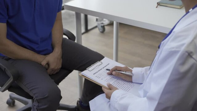 Man with benign prostatic hyperplasia being examined and consulting Asian female doctor and The doctor will ask about the patient's illness and give health advice.
