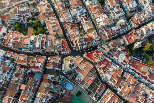 Aerial top down view of Sitges downtown with red rooftops and residential district, Barcelona, Spain.