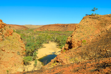 Viewing platform overlooking Ormiston Gorge in dry season. Northern Territory, Outback Red Center. Lookout platform aerial view along Ghost Gum walk in West MacDonnell Ranges, Central Australia.