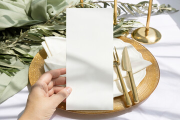 Menu 4x9 mockup on hand with gold cutlery on olive branch background