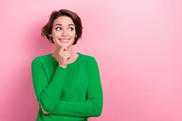 Photo of lovely positive girl wear green pullover arm touch chin look up empty space interesting...