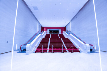 Escalators and stairs in the modern exhibition hall, marble architecture style.
