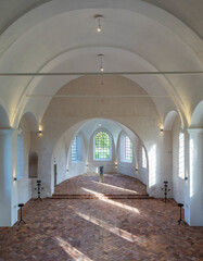 Interior of lutheran church. Spacious hall. White walls. Huge arch windows.
