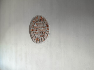 Interior of Mežotne Lutheran Church in Latvia. Brick circle on white wall.