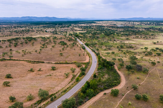 Aerial view of a road crossing the countryside along the Spanish and Portuguese border, Zebreira, Castel Branco, Portugal.