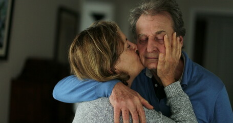 Senior wife kissing husband older couple love and affection