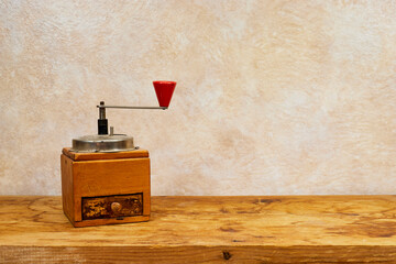 Vintage manual coffee grinder on wood table