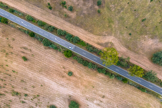Aerial view of vehicles driving on the road crossing the countryside along the Spanish and Portuguese border, Zebreira, Castel Branco, Portugal.