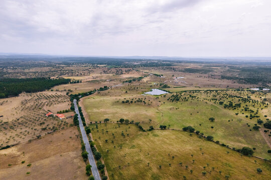 Aerial view of a road crossing the countryside along the Spanish and Portuguese border, Zebreira, Castel Branco, Portugal.
