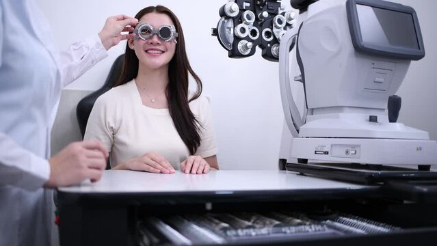 Woman optical shop customer doing eyesight measurement with optical phoropter check eye distance for eyeglasses is optical  eye shop service.