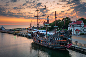 Pirate ship in Ustka by the Baltic Sea at sunrise, Poland.