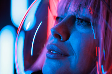 Beautiful woman in futuristic costume over dark background. Girl in 3d glasses of virtual reality....
