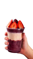 Hand holding a cup of açaí 