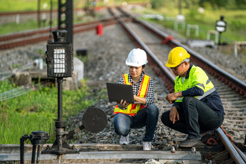 Architects and engineers use laptop technology and construction innovations to inspect the train...