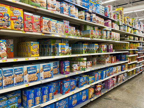 The breakfast cereal aisle  at a Walmart Store with no people.