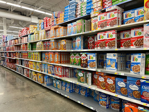 The breakfast cereal aisle  at a Walmart Store with no people.