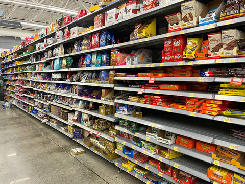 The chocolate candy aisle  at a Walmart Store with no people.