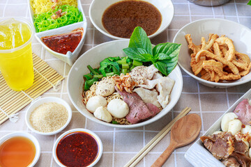 Thai boat noodles with Thai spices and ingredient on background.