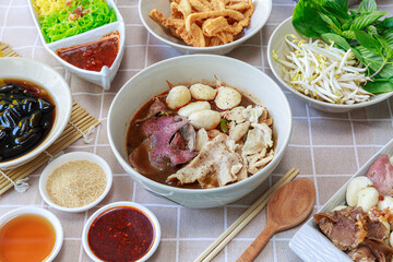 Thai boat noodles with Thai spices and ingredient on background.