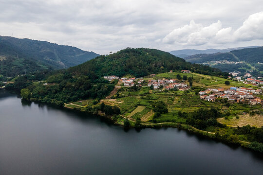 Aerial view of a small village along the Minho river in Val de Pereira, Ourense, Spain.
