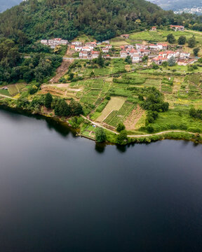 Aerial view of a small village along the Minho river in Val de Pereira, Ourense, Spain.